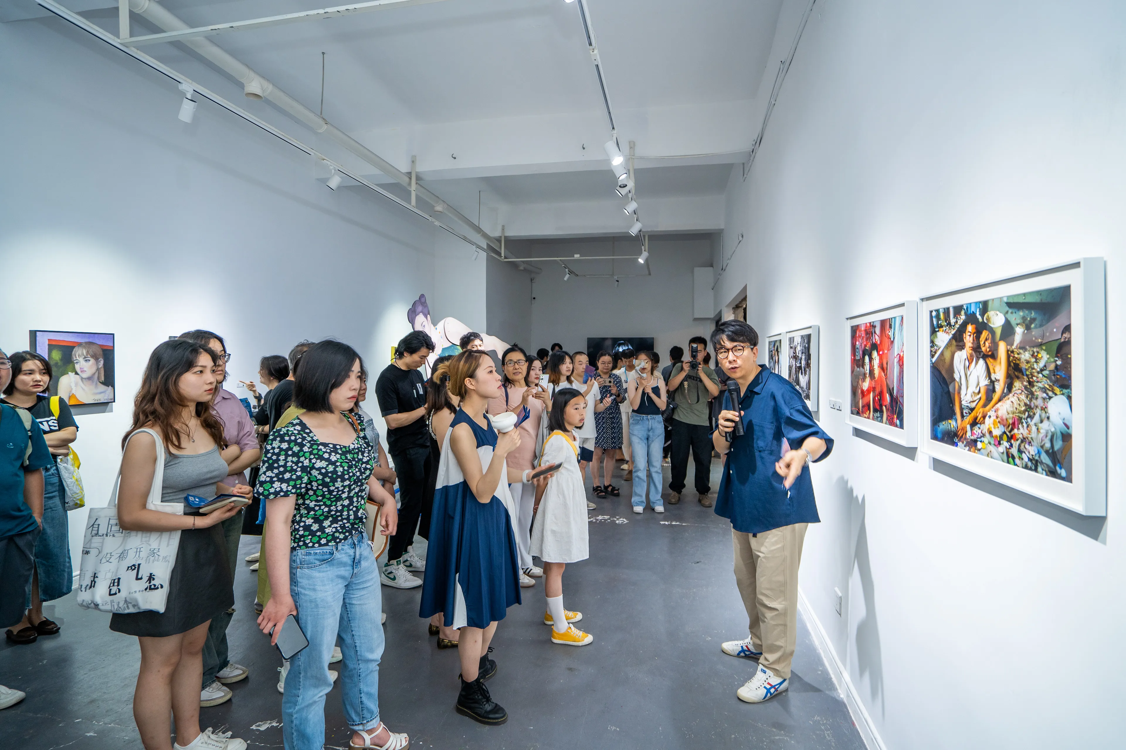 Visitors at Forward Art Gallery in Changsha, gathered in front of framed prints from my AI-generated portrait series Lovers.